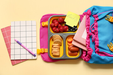 Lunch box with tasty food and school backpack on yellow background
