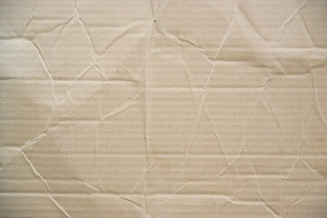 Fototapeta premium Craft crumpled paper, cardboard background. Brown kraft sheet texture, torn antique page, wallpaper or parchment abstract design, Horizontal rough carton