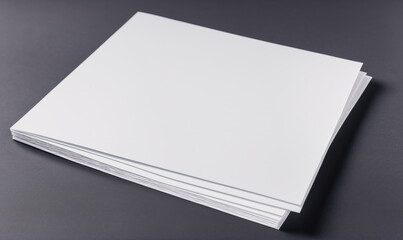 A stack of white paper sits on a gray surface