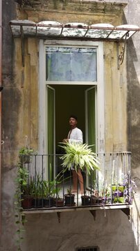Man Standing on Traditional Balcony in Naples Italy