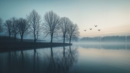 Fototapeta premium Serene Winter Lake with Bare Trees and Flying Birds at Dusk