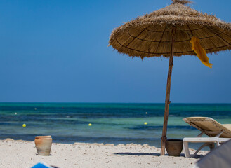 Beach with umbrellas and sun loungers