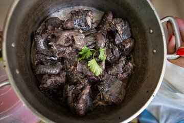 Detail of lamprey cut into pieces already cooked in the pan.