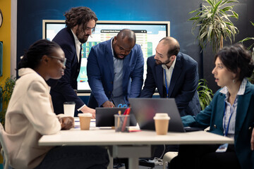Business affiliates are meeting in conference room office to discuss environment news and updates within the corporation. Workmates and supervisor training to become a multinational firm.