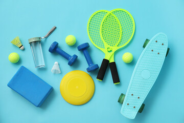 Set of sports equipment on blue background, top view