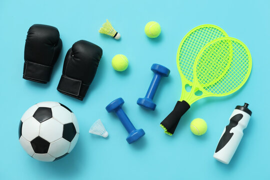 Set of sports equipment on blue background, top view