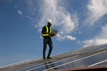 worker installing solar photovoltaic panels on a roof, Solar power plant engineers, and examining...