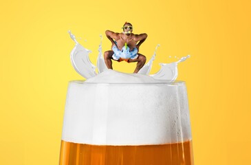 Man in swimsuit floating at top of foamy beer glass