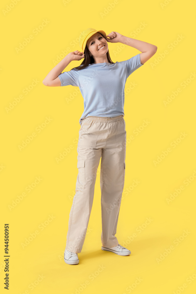 Poster Young woman in bucket hat on yellow background