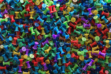 several assorted colors of plastic push pins
