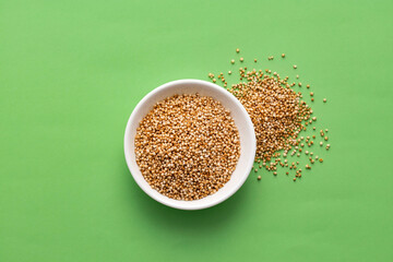 Amaranthus - Organic amaranth pops in the bowl. green background