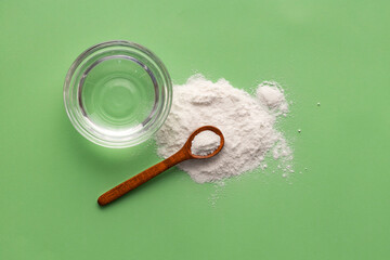 Baking soda powder in spoon and mineral water - Healthy food