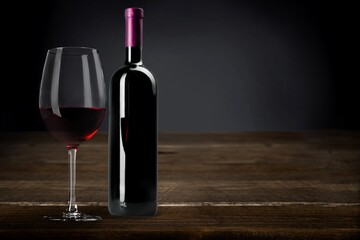 Bottle and glass of sweet alcohol red wine