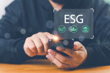 Businessman with ESG icon of saving clean energy environmental, social, governance, sustainable and corporation development, green eco friendly, environment, go green, CO2, ESG concept