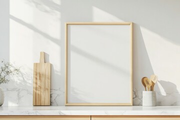 A modern kitchen features an empty picture frame in soft natural morning light, highlighting minimalist design and contemporary decor elements.