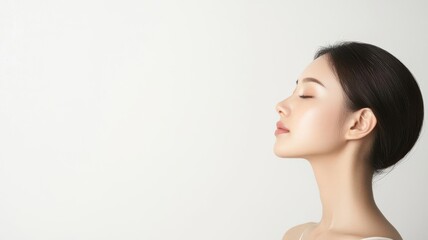Fototapeta premium Close-up of an Asian woman with soft, luminous skin, natural makeup emphasizing her healthy glow, luminous skin, natural makeup, radiant beauty