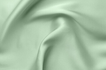 Crumpled sage color silk fabric as background, top view