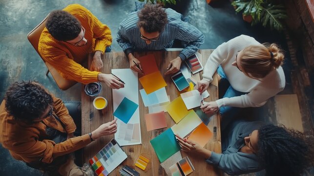 Creative design team collaborates on color palette at a modern workspace in the late afternoon - Powered by Adobe