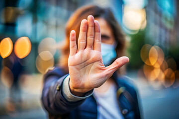 Woman In Face Mask Holding Hand Up, Stop Sign.