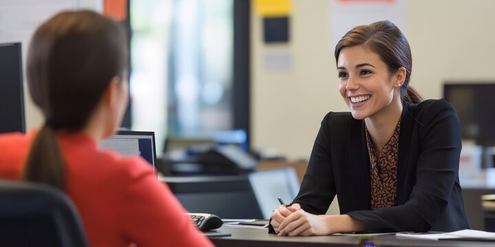 Professional customer service representative engaging in a positive client interaction with a friendly smile and attentive listening in a modern office environment