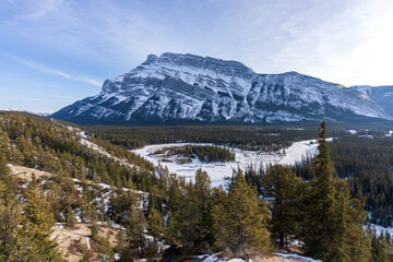 Banff National Park beautiful landscape. Panorama view Mount Rundle valley forest and frozen Bow River in winter. Hoodoos Viewpoint, Canadian Rockies. © Shawn.ccf