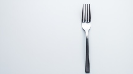 Isolated metallic fork elegantly positioned diagonally on a crisp white background. Subtle lighting creates a clean and minimalist kitchen utensil presentation.