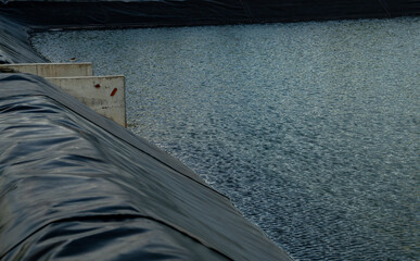 Aquaculture farming pond liner system. HDPE geomembrane technology. Water containment and environmental protection in sustainable fish farming. High-density polyethylene transforms aquaculture ponds.