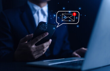 Businessman using laptop with email on virtual screen and new email with email communication notification