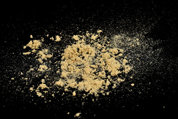 Yellow sand is scattered on a black background.