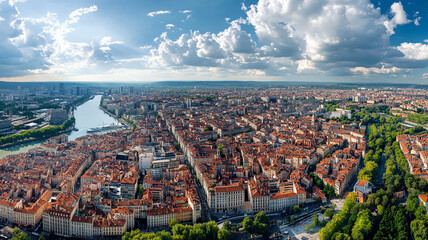 Obraz premium Aerial view of Lyon's vibrant urban landscape featuring historic architecture and green spaces along the river in sunny weather