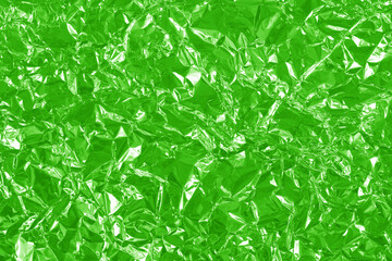 Green lime foil shiny texture, abstract wrapping paper for background and design art work.