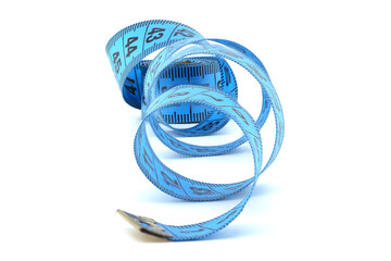 Blue measuring tape coiled on a white background representing precision, fitness, and tailoring