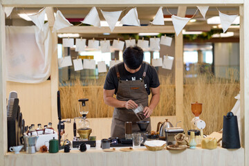 barista is preparing equipment for making coffee.