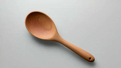 Title: A warm natural wooden spoon with a smooth work surface.

