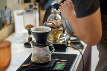 barista is preparing equipment for making coffee.