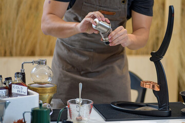 barista is preparing equipment for making coffee.