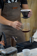 barista is preparing equipment for making coffee.