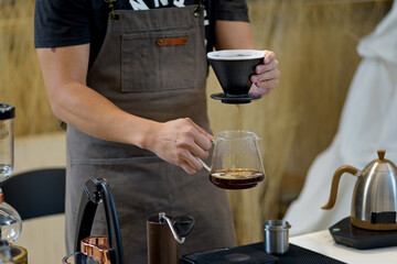 barista is preparing equipment for making coffee.