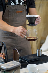 barista is preparing equipment for making coffee.