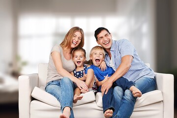 Happy young family relaxing at home