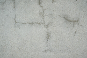 Grey cement wall with cracked or scratched on surface. Background and texture, close-up. 