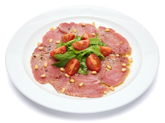 cooking tuna carpaccio - Fresh raw tuna fillet with olive oil and pine nuts on white ceramic plate