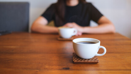 Closeup image of a woman drinking coffee with friend