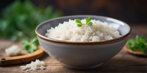 Freshly steamed white rice in ceramic bowl on rustic background.