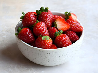 Fresh strawberries in a white ceramic bowl.