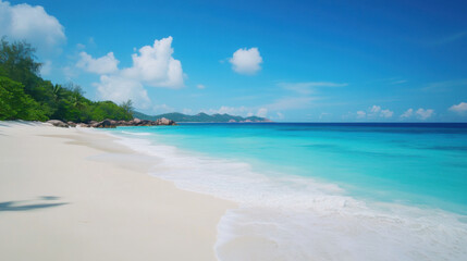 Pristine white sandy beach in Seychelles with crystal clear turquoise waters stretching far