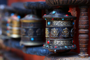 Prayer Wheels in Nepal. Traditional Tibetan Buddhist prayer wheels, intricately designed and spinning with devotion, symbolize the spiritual practices and cultural heritage of Nepal.