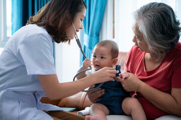 Fototapeta premium A little child and his family visit the doctor for a routine health checkup