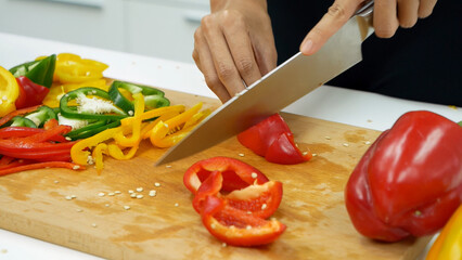 Close up Women hand prepare fruit vegetables vegan salad season oil salad dressing green oak red oak lettuce at home kitchen. Women hands cooking vegan healthy fresh fruit tomato pepper vegetables