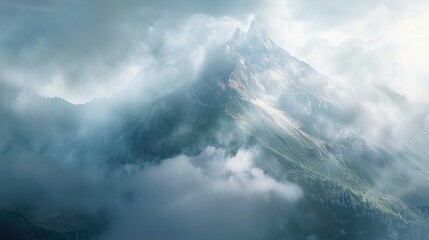 A tranquil mountain peak shrouded in mist, with sunlight breaking through the clouds and casting a heavenly glow over the rugged terrain below.